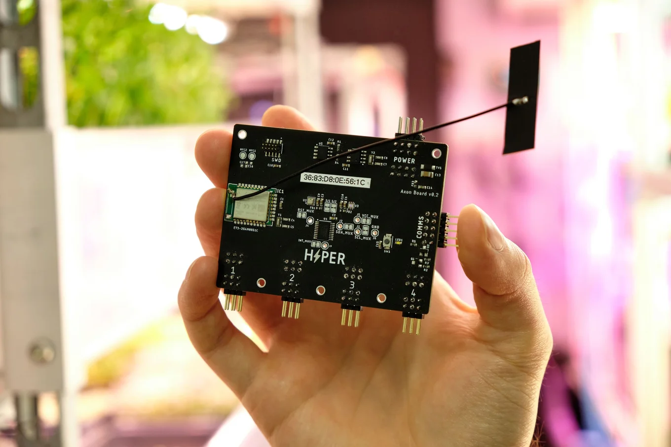 Hand holding a circuit board with the label "HYPER".